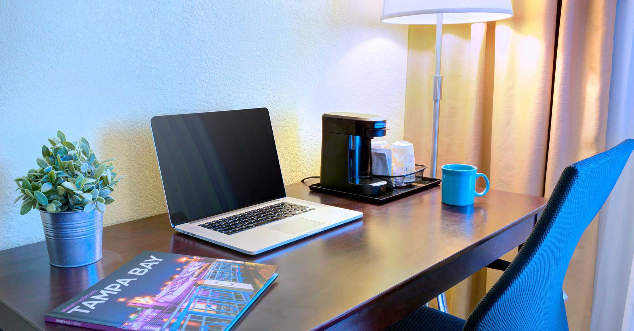 closeup view of work desk with laptop in one-king guest room