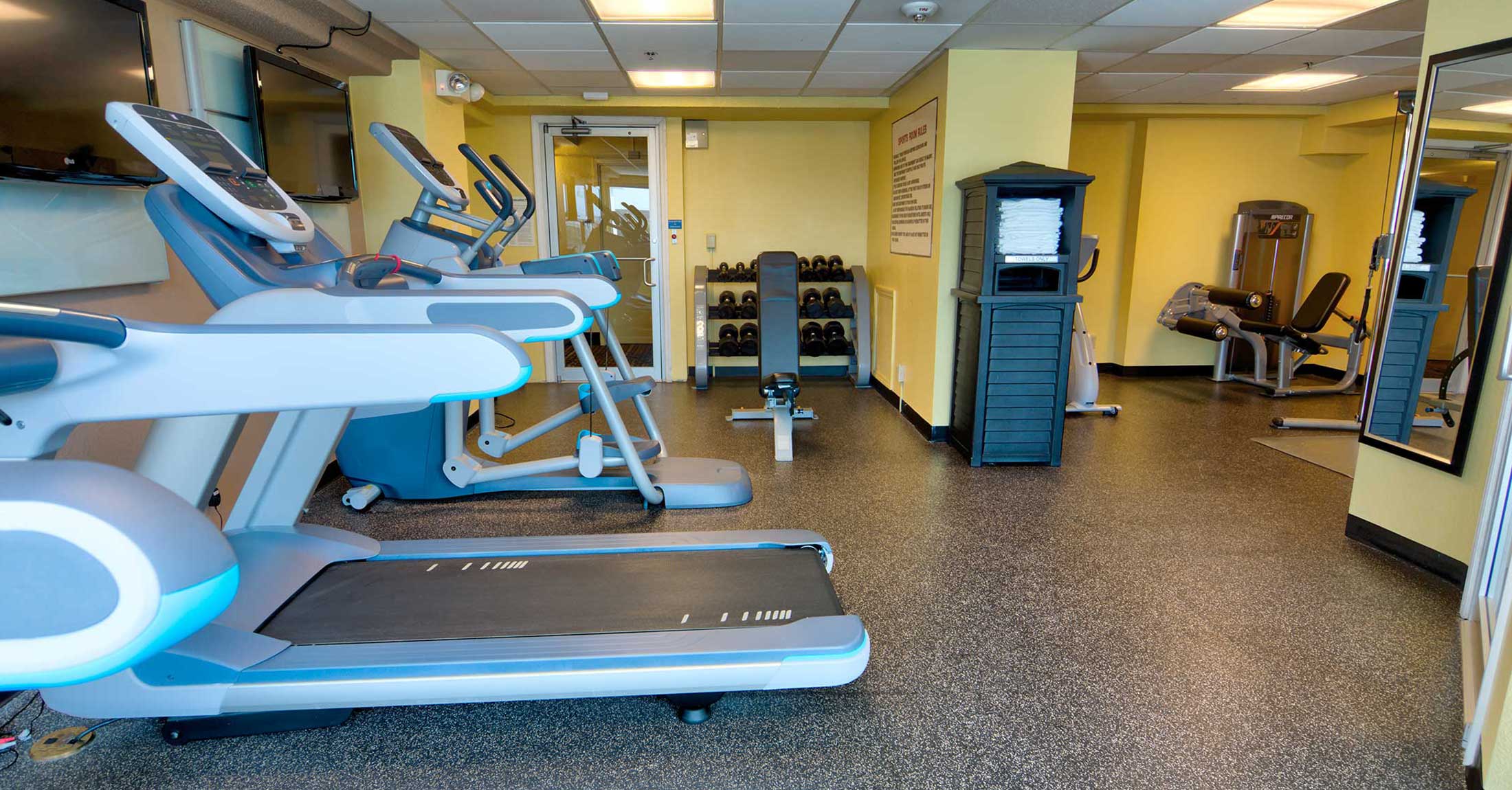 fitness center view from opposite side of room and treadmills