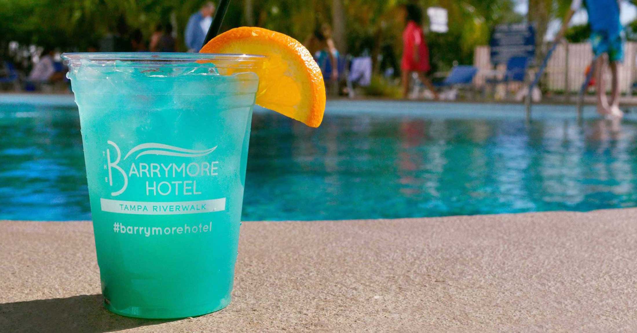 bright blue cocktail on the edge of the pool