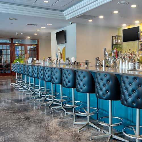 alternate view of long full bar and bar stools